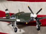 a small model of a plane on display in front of an american flag