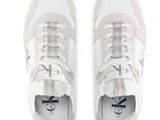 white sneakers with silver details on the soles of them