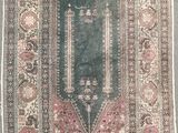 an antique rug with a green border and a pink border