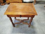 a small table with a drawer on it in the middle of a room