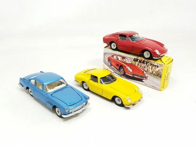 three toy cars sitting next to each other on a white surface