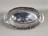 a silver plate with a mirror in it on a table