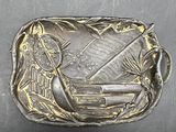 an old belt buckle with a picture of a boat on it