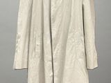 beige trench coat on a hanger on a gray background