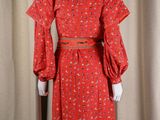 a woman ' s red dress with a floral pattern on it