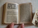 a person holding an open book on a table