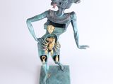 statue of a woman with a scorpion on her back