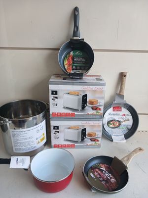 several pots and pans sitting on top of a counter next to a box of food