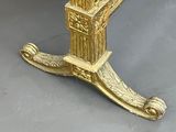 a gold colored bed with a mirror on top of it