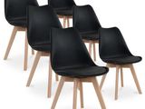lot de quatre chaises de salle à manger en cuir noir avec des pieds en bois