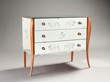 a white chest of drawers with a glass top