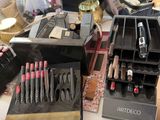 a lot of makeup items on a table in a room