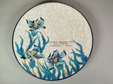 a plate with a picture of a flower on it