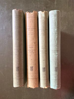 three old books sitting on top of a table next to each other