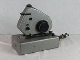 an old camera that is sitting on a white surface