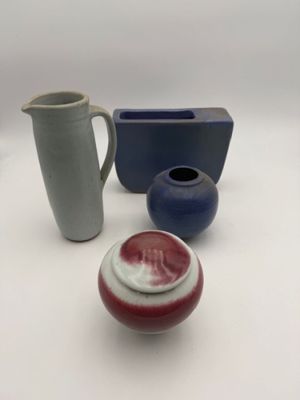 three different types of vases on a white table