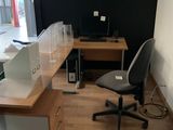 a desk with a chair and a computer on it