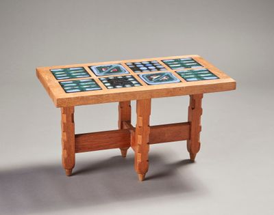 a wooden table with a tile top on it