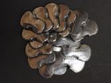 a bunch of silver spoons sitting on a black surface