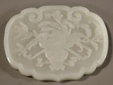 a picture of a white glass plate with a bird and flowers design