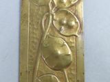 a close up of a metal plaque with a flower on it