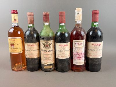 several bottles of wine are lined up in a row