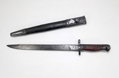 a knife and a knife holder on a white surface