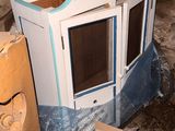 a small cabinet in the middle of a pile of boxes