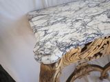 a marble top table with a gold frame on top of it