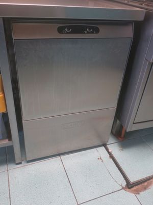 a silver dishwasher sitting in the middle of a kitchen