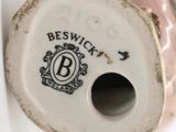 a white vase with a black and white logo on it