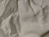 a close up of a bed with a white sheet on it