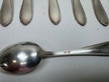 several spoons and spoon spoons are lined up on a table