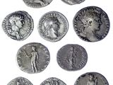 a close up of a bunch of silver coins on a white surface