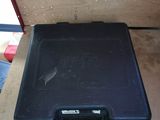a black briefcase sitting on top of a wooden table