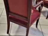 a red chair that is sitting in the middle of a room