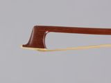 a close up of a violin bow on a gray background