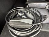 a cord that is connected to a charger in the back seat of a car