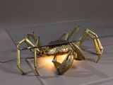 a glass table with a gold crab on it