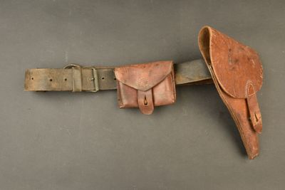 a close up of a leather belt with a knife in it