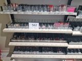 many different shades of lipstick on the shelves in the store