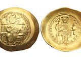a close up of a gold coin with a picture of a man on it