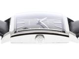 a close up of a watch with a black leather strap