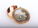 an image of a gold plate with a painting on it