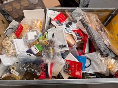 a metal container filled with assorted items on a table
