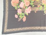 a black table cloth with pink flowers on it
