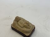 a small statue of a person on a white surface