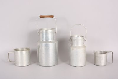 three silver metal containers and a wooden handle on a white surface