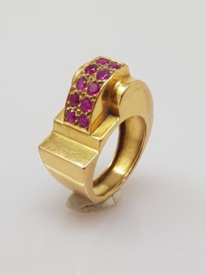 an image of a gold ring with pink stones on it