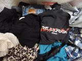 a pile of clothes that is on a couch